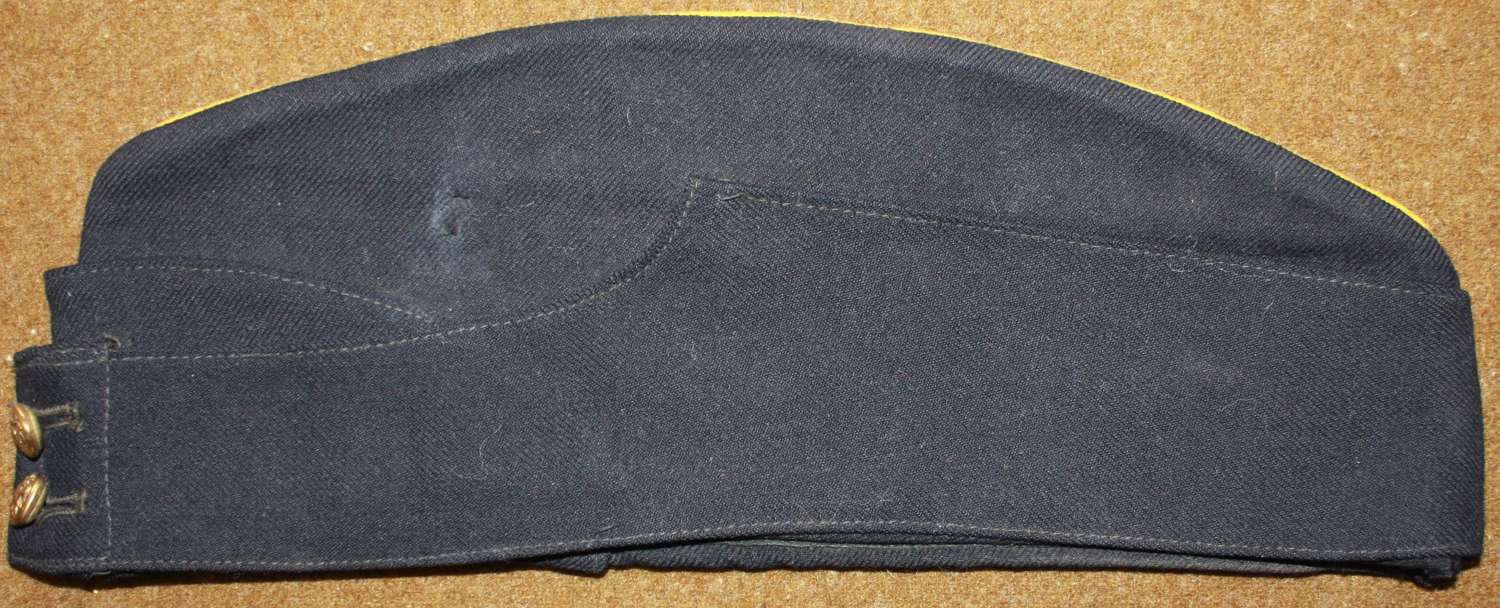 A WWII PERIOD BRITISH SIZE 7 1/8 BLACK SIDE CAP WITH YELLOW PIPING