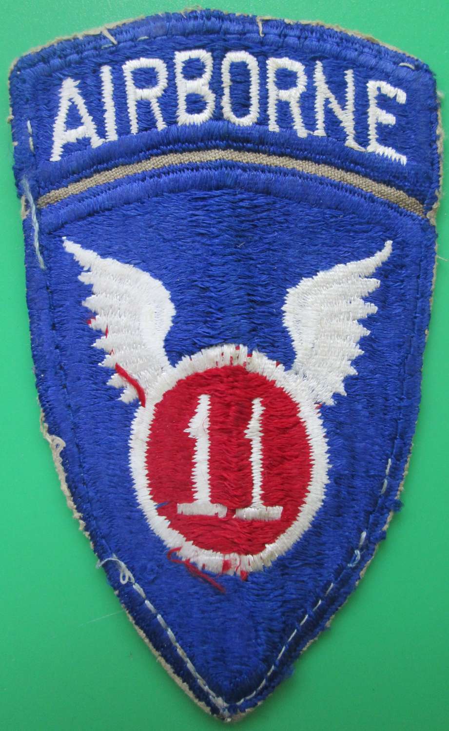 A WWII US ARMY 11TH AIRBORNE ARM BADGE SIGN
