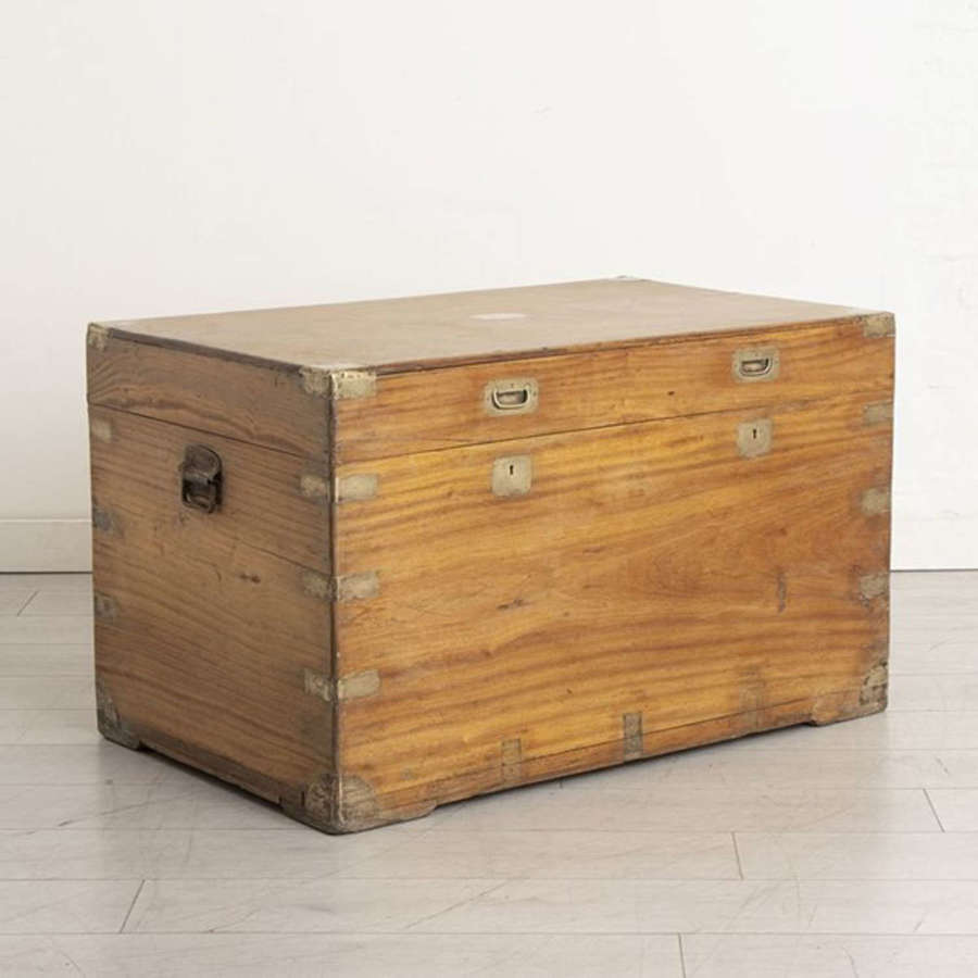 An antique camphorwood trunk with brass bindings and fittings.
